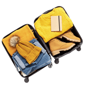 Open suitcase with winter clothing and shoes.