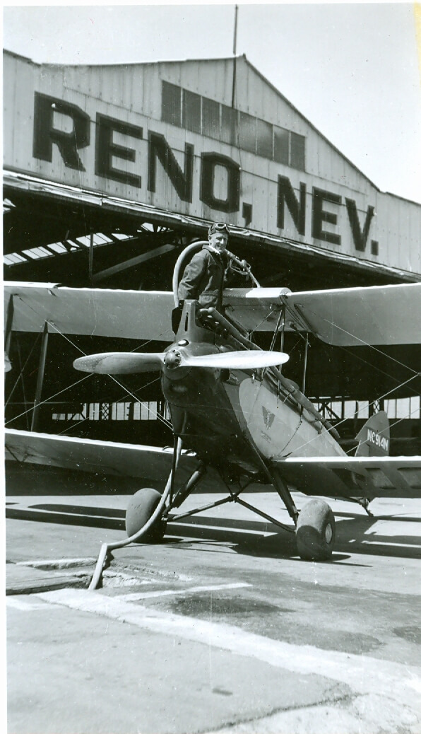 Historic black and white photo of pilot and aircraft in Reno.