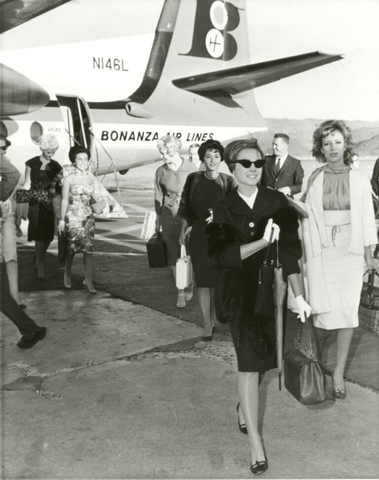 Historic photo of passengers exiting Bonanza Air Lines aircraft.