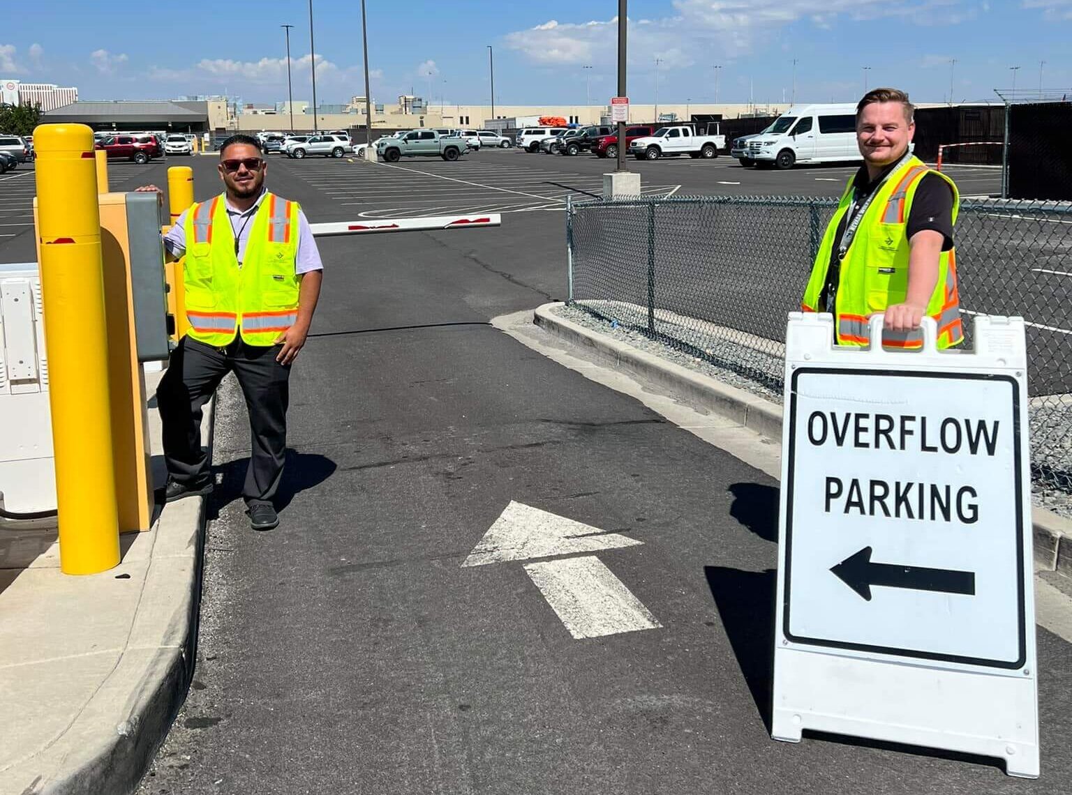 Parking team with sign reading "Overflow Parking".