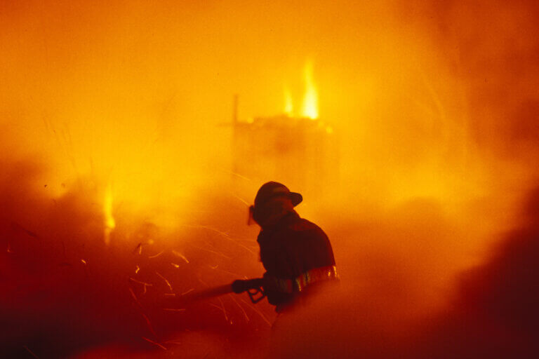 Firefighter in the middle of fighting a fire from Photography by Marilyn Newton Exhibit.