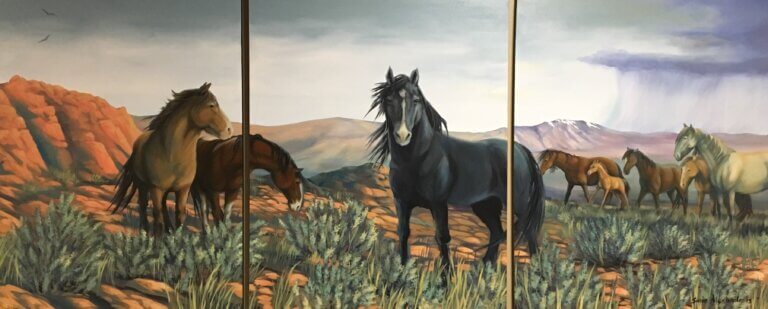 Wild Horses exhibit art piece featuring multiple horses and desert background.