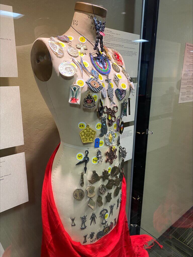 Mannequin with various Burning Man pins attached.