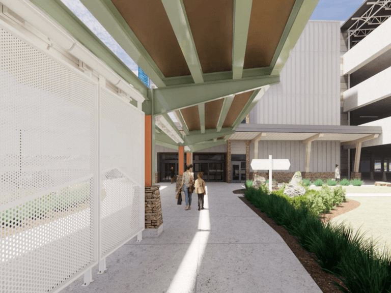 Woman and girl walking under covered walkway