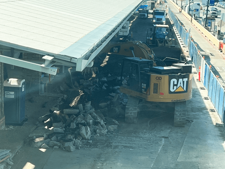 Construction equipment demolishing concrete