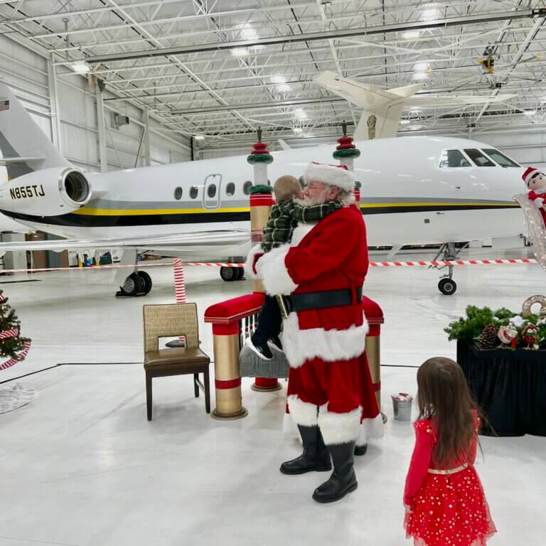 Little boy hugs Santa Claus