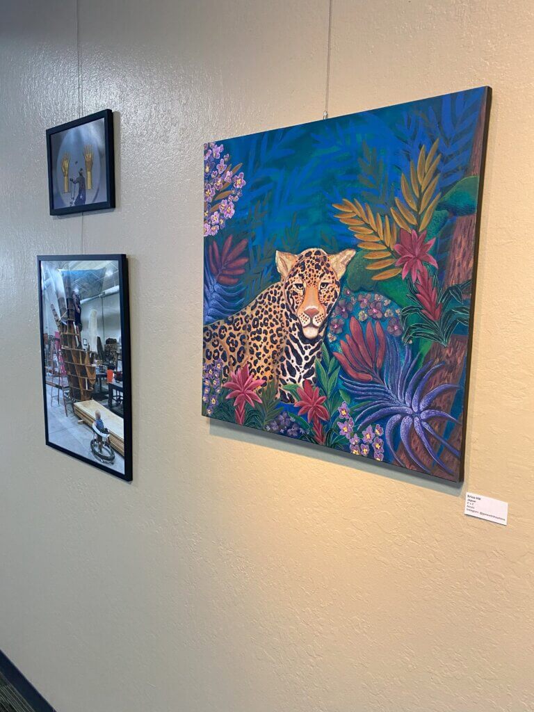 Artwork depicting jaguar in the wild. Photographs of Generator artist building a large scale piece involving two golden hands with rings hanging in-between them.