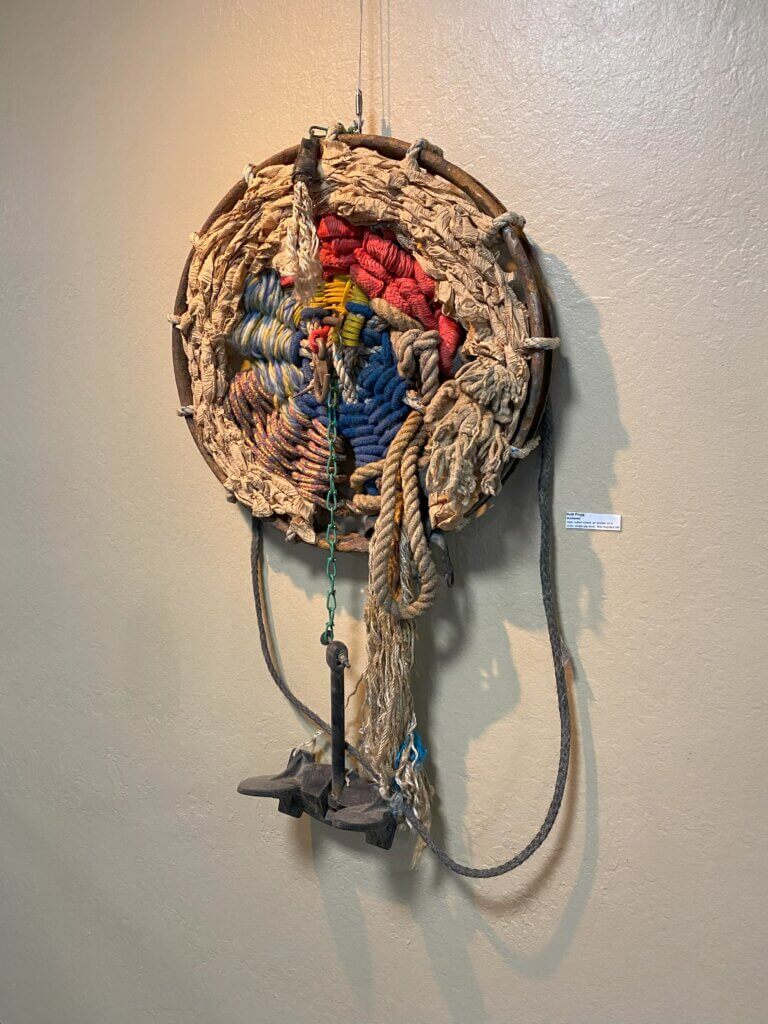 Artwork made with recycled materials including ropes, chains, and an anchor.