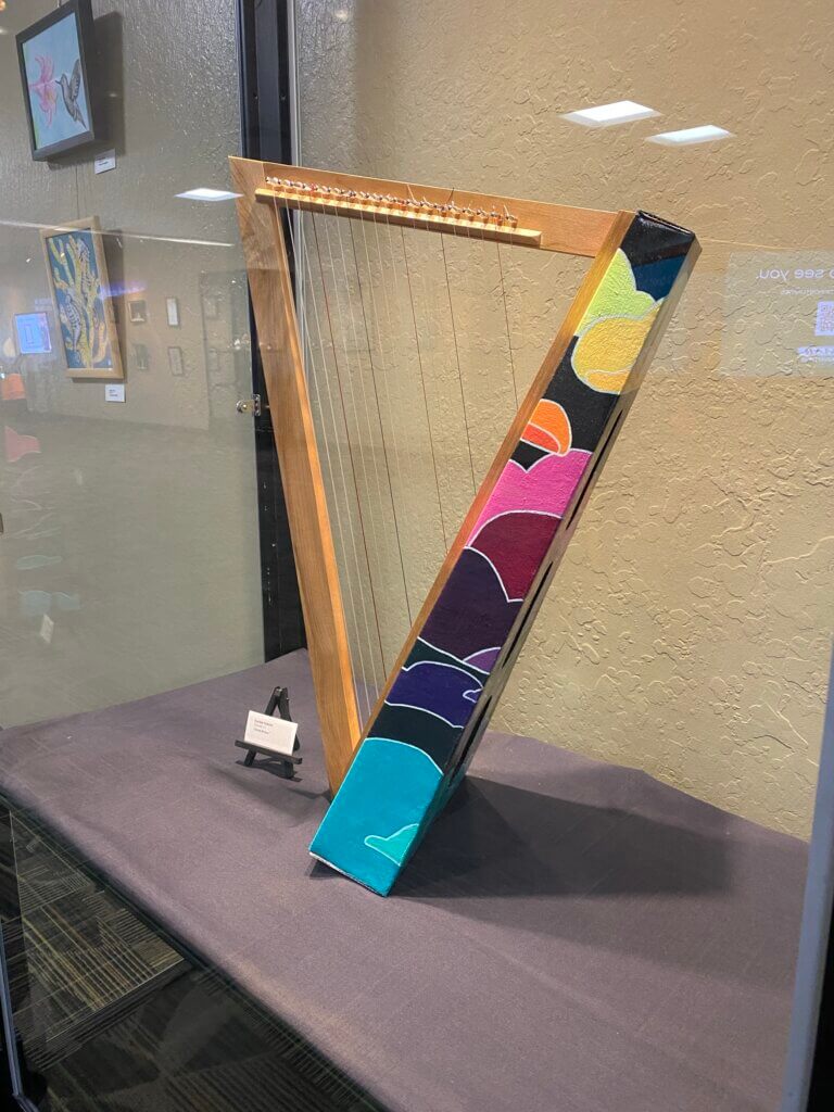 Colorful harp inside a display case.